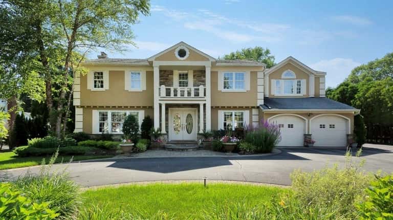 This five-bedroom Dix Hills Colonial, listed for $899,000 in January...