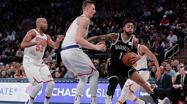 Nets guard D'Angelo Russell drives to the basket against Knicks...