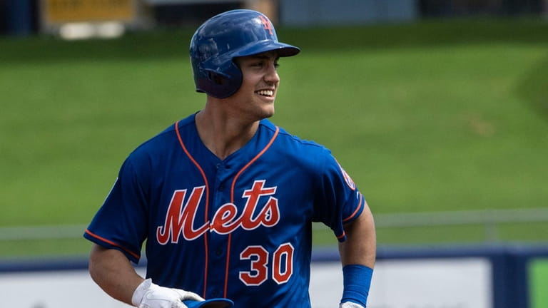 New York Mets outfileder Michael Conforto runs to third base...