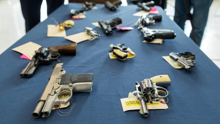 Illegal handguns seized by the Suffolk County Police Department displayed...