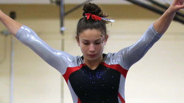 Madisyn Rodriguez of Middle Country performs on the beam during...