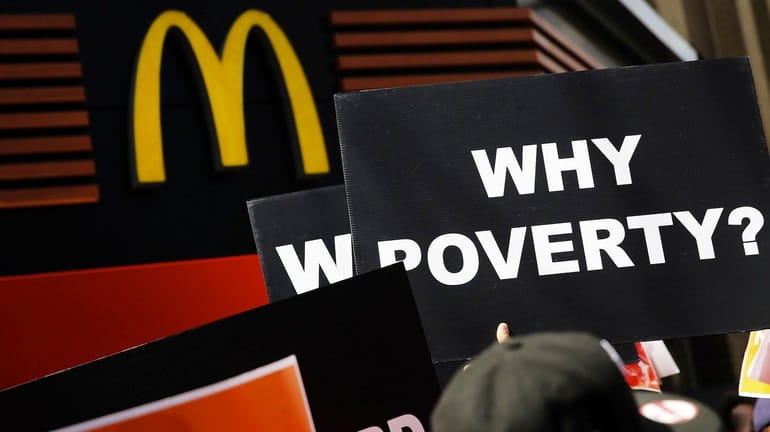 Low wage workers, many in the fast-food industry, join with...