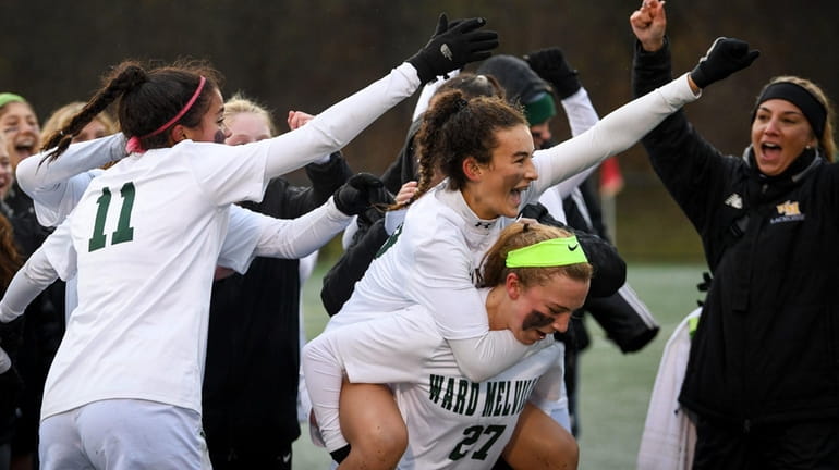 Ward Melville's Amelia Pirozzi, facing, is carried by Peyton Costello...
