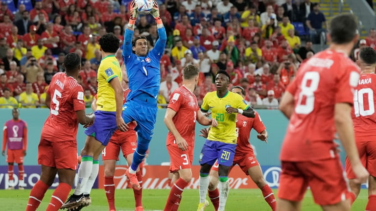 Switzerland's goalkeeper Yann Sommer, top, catches the ball during the...