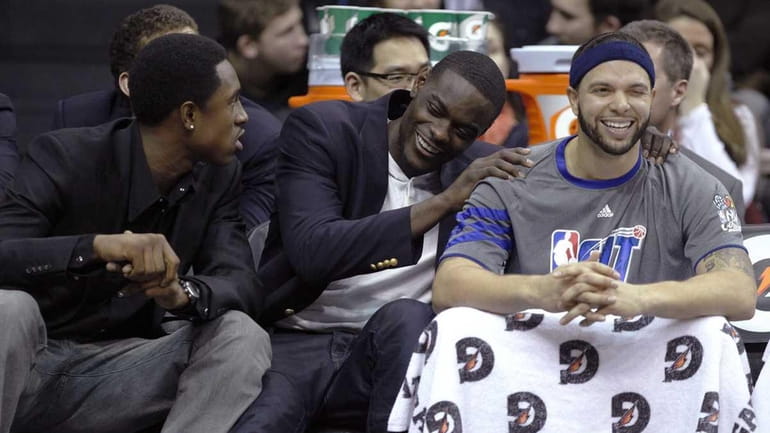New Jersey Nets' Deron Williams, right, laughs with teammates MarShon...