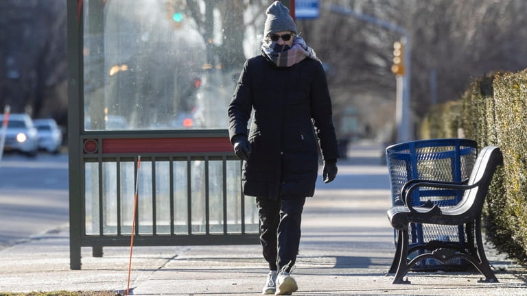 A bundled-up pedestrian walks along Franklin Avenue in Mineola on Friday.