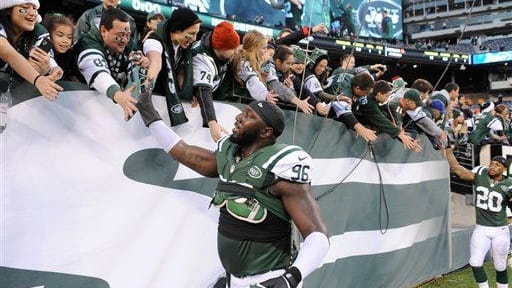 Muhammad Wilkerson reacts with fans after a game against the...