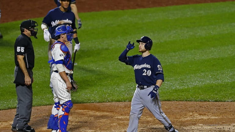 Jonathan Lucroy of the Milwaukee Brewers gestures after hitting a...