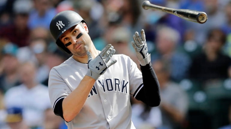 The Yankees' Neil Walker flips his bat after striking out...