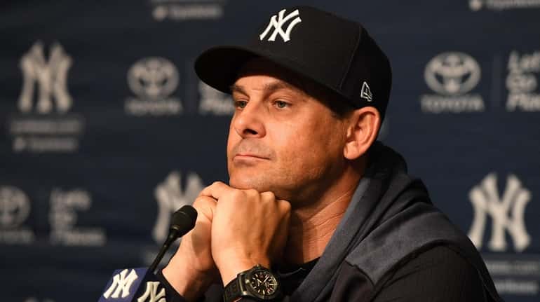 Yankees manager Aaron Boone looks on during a press conference...