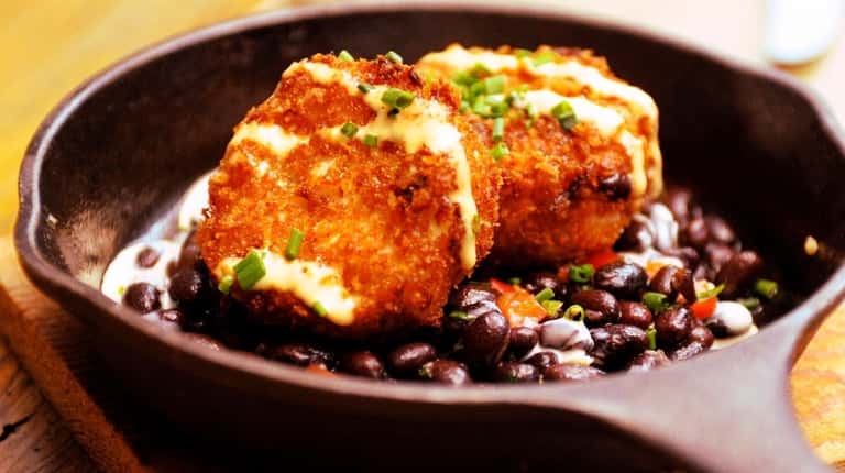 Crab cake with black bean salsa with chili aioli is...