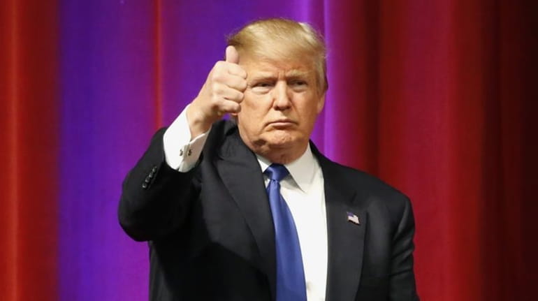 Presidential candidate Donald Trump gives a thumbs-up to supporters after...