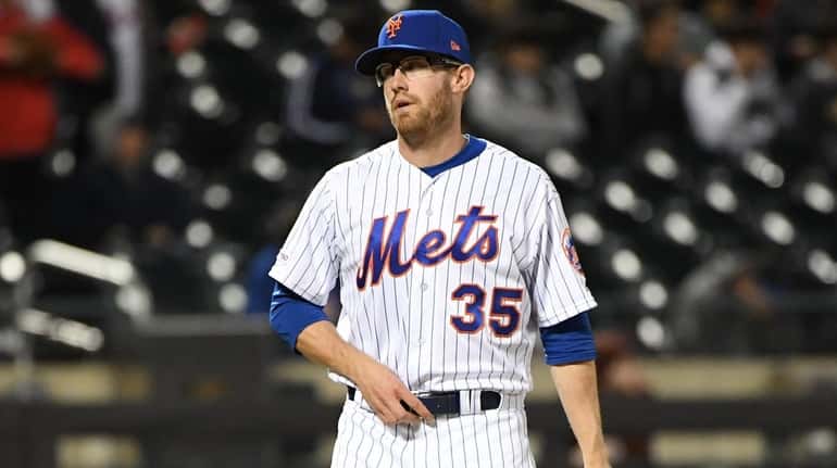Mets relief pitcher Jacob Rhame looks on after giving up...