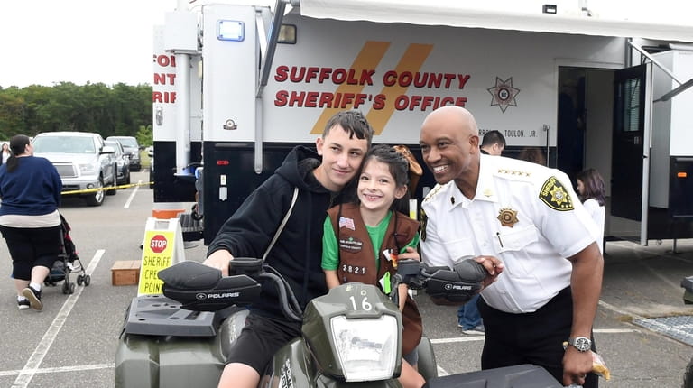 Suffolk County Sheriff Errol D. Toulon Jr. with siblings Jack,...