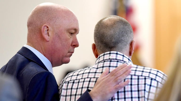 Attorney Rus Rilee, left, comforts his client, David Meehan, before...
