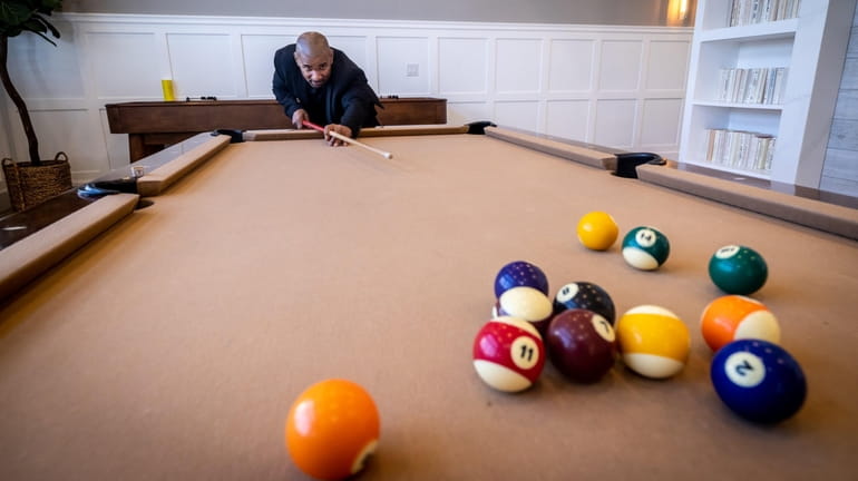 Retired correction officer Aaron Jenkins enjoys the billiard room at...