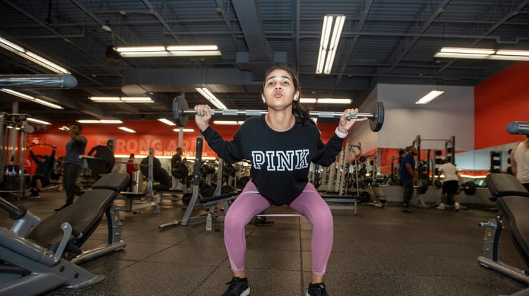 Layris Estevez Abreu, 21, of Copiague gets a weights workout at...