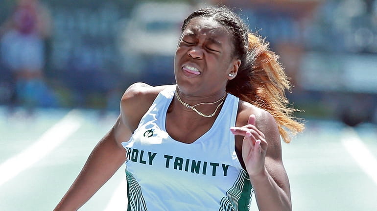 Holy Trinity’s Logan Daley wins the 100 meter in a...