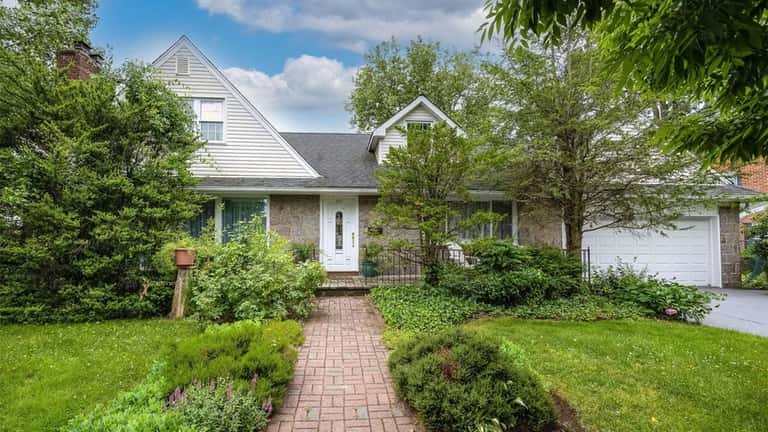 Priced at $874,888, this expanded Cape on Birch Road features...