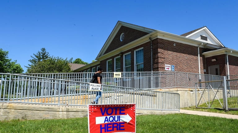 A voter leaves the Wyandanch school district's Central Administration Building on...