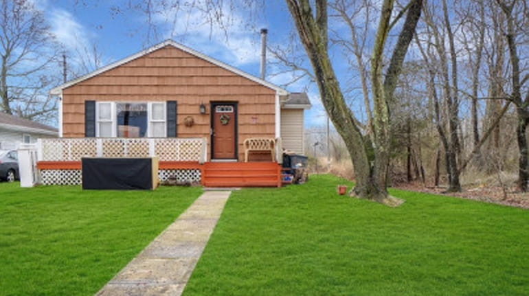 This Mastic Beach home  has three bedrooms, one bathroom and high-hat...
