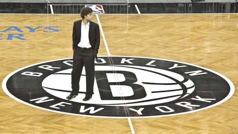 Brooklyn Nets basketball player Brook Lopez walks onto the floor...