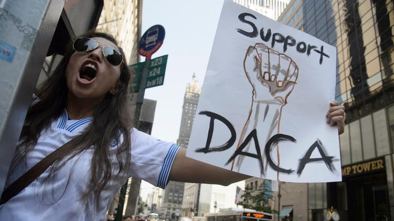 Dayana Arrue, a DACA recipient from El Salvador, protests on...