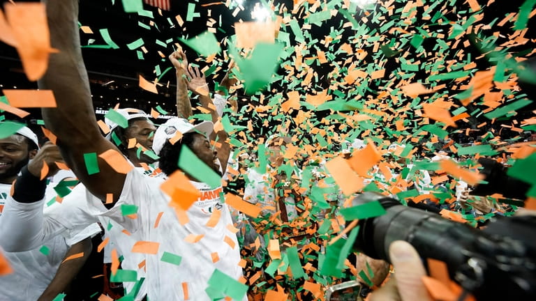 Miami celebrates after their win against Texas in an Elite...