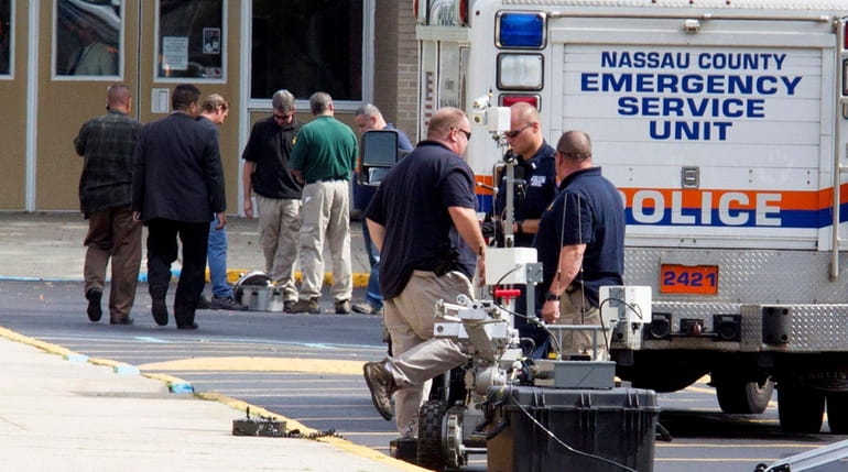 Nassau County police's Arson/Bomb Squad at the scene after a...