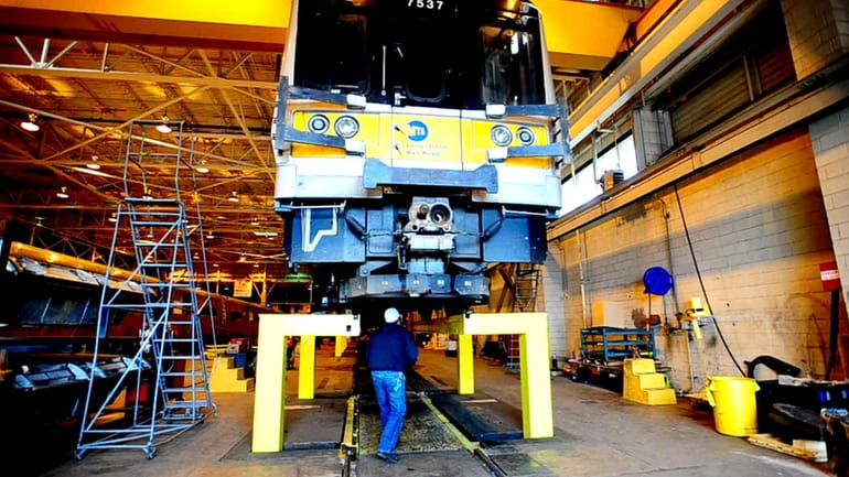 MTA workers work on LIRR equipment at the Hillside facility....
