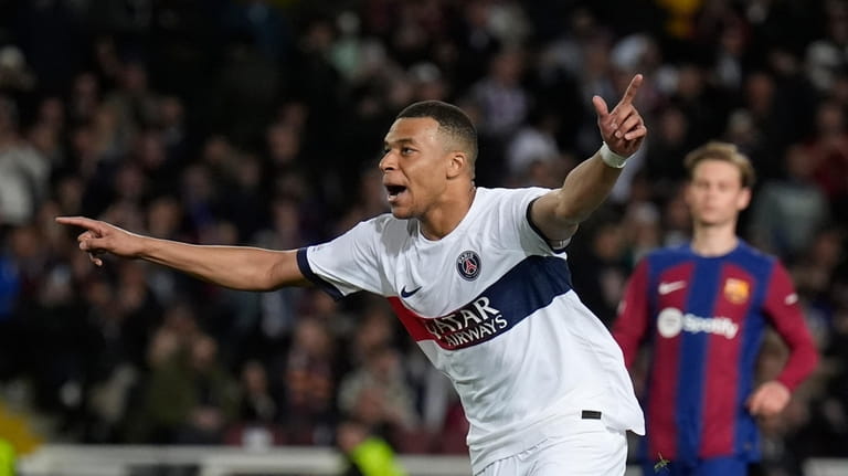PSG's Kylian Mbappe celebrates after scoring his side's third goal...
