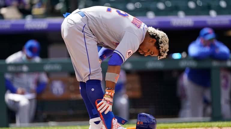 The Mets' Francisco Lindor leaves his gear at home plate...