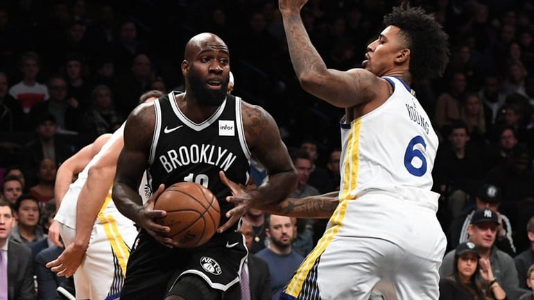 Nets forward Quincy Acy drives, defended by Warriors guard Nick...