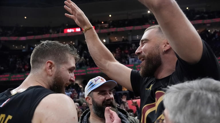 Cleveland Cavaliers forward Dean Wade, left, celebrates with Jason Kelce,...