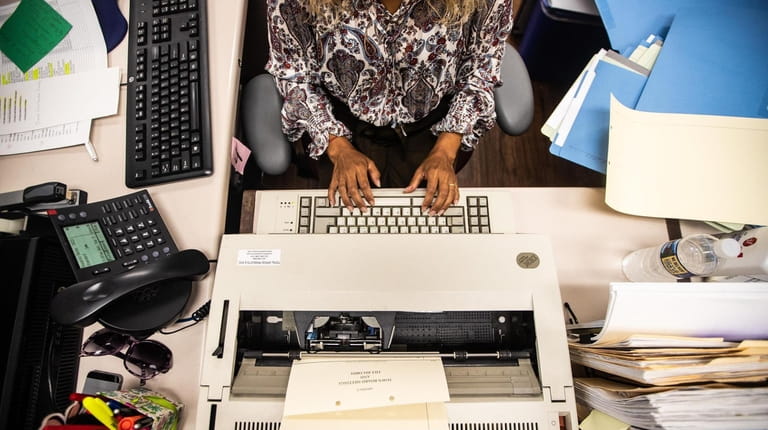 A Hempstead Town employee at her desk in September 2018. Many...
