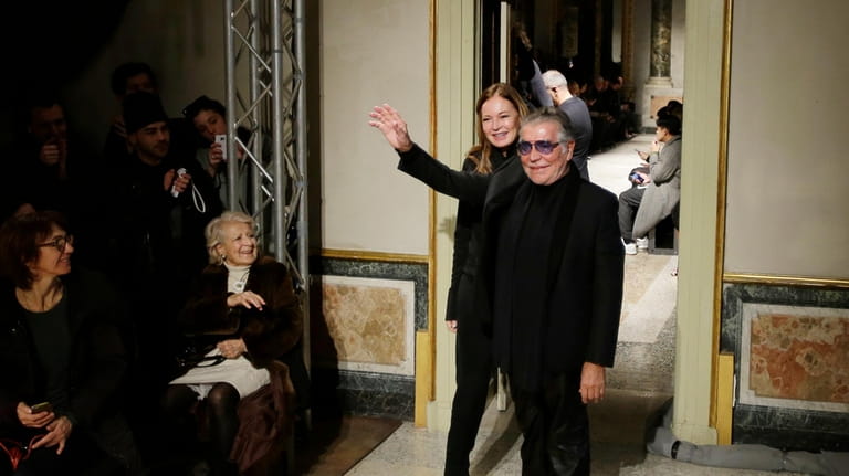 Fashion designer Roberto Cavalli and his wife Eva Duringer acknowledge...