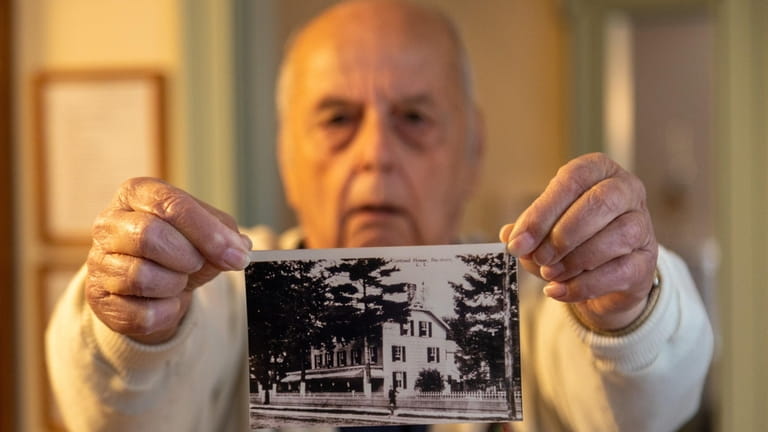 Ernest Pontes, 83, holds a picture of the Cortland House...