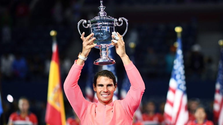 Rafael Nadal poses with his winning trophy after defeating Kevin...