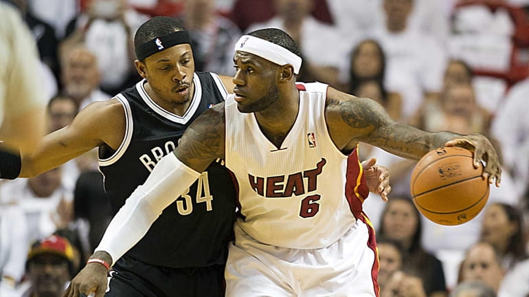 Paul Pierce checking Miami Heat's LeBron James in the first...