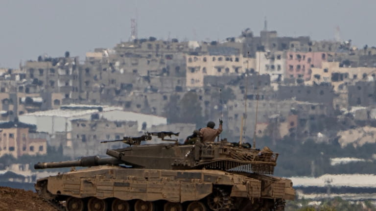 An Israeli soldier on top a tank on the border...