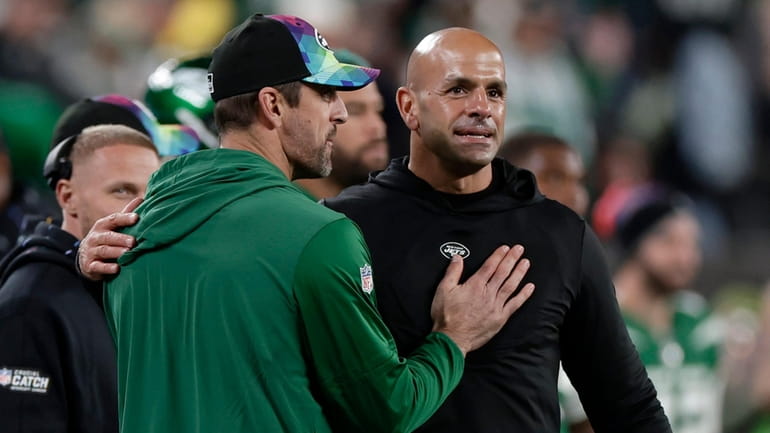 Aaron Rodgers of the Jets and head coach Robert Saleh react...