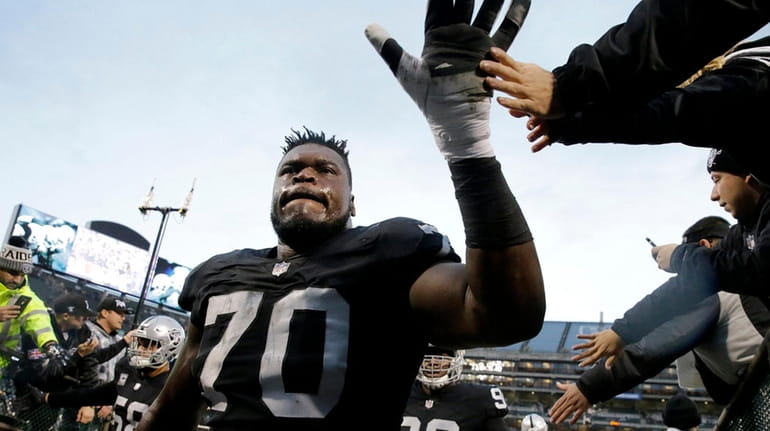 Oakland Raiders offensive tackle Kelechi Osemele (70) greets fans before...