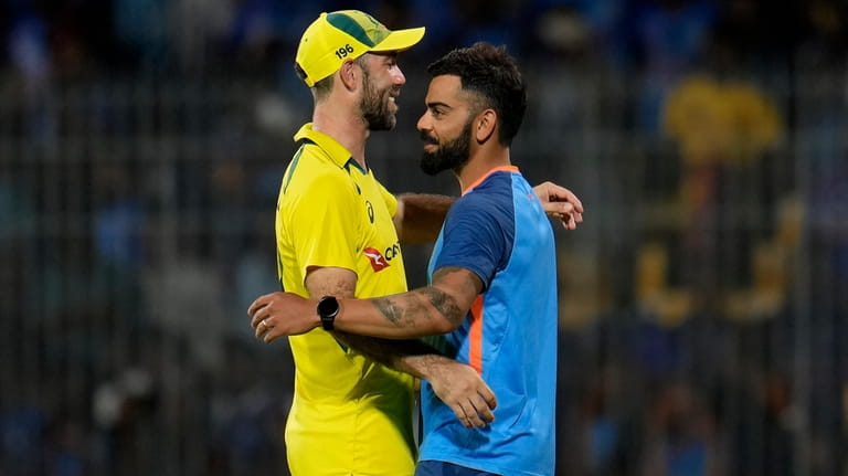 India's Virat Kohli, right, greets Australia's Glenn Maxwell after Australian...
