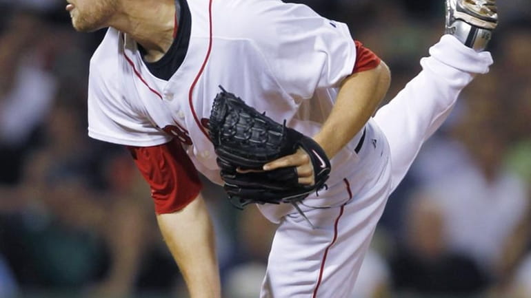 Boston Red Sox pitcher Daniel Bard follows through on a...
