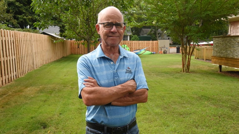 Gary Lynott built a 200-foot-long board-to-board fence in his backyard in East...