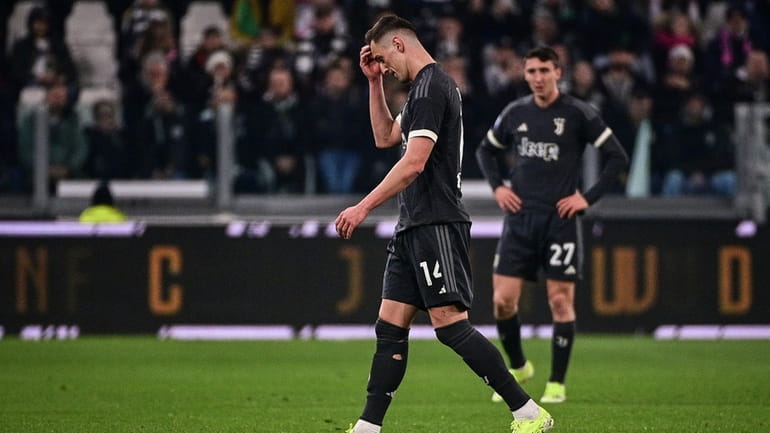Juventus' Arkadiusz Milik walks off the pitch after receiving a...