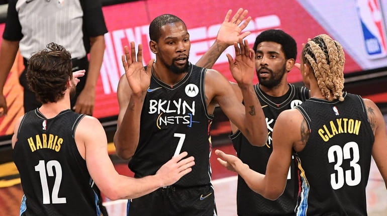 Nets forward Kevin Durant and teammates react against the New...