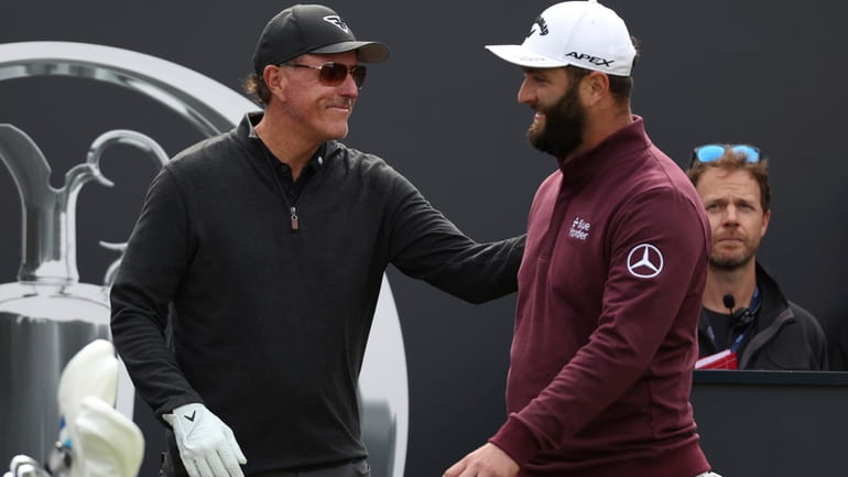 Spain's Jon Rahm, right greets United States' Phil Mickelson on...
