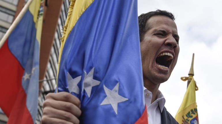 Juan Guaido, president of the National Assembly, yells during a...