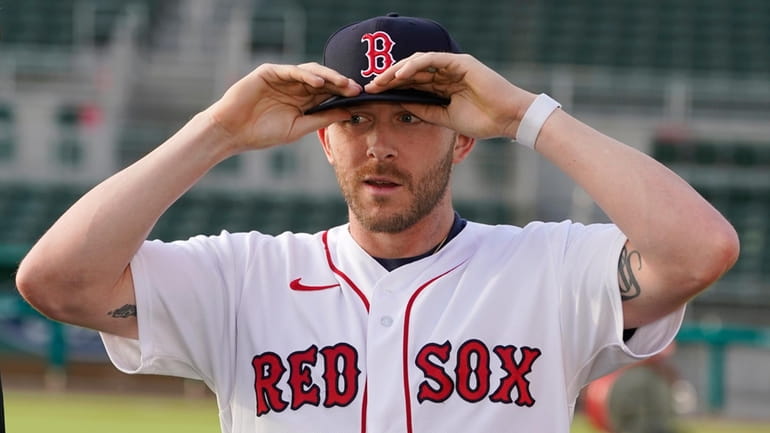 New Boston Red Sox shortstop Trevor Story adjusts his ball...